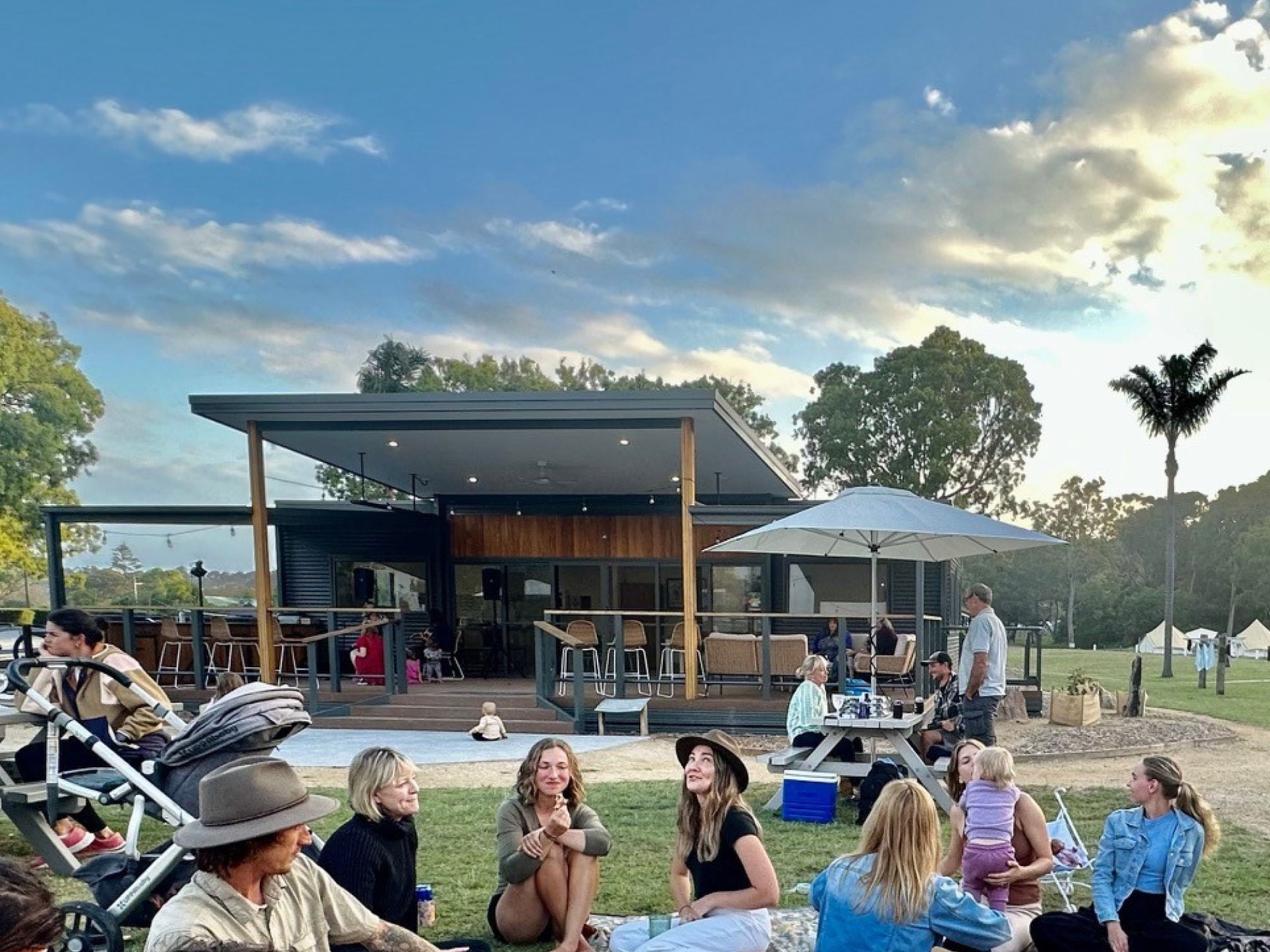 Tathra beach eco camp view of people sitting and talking