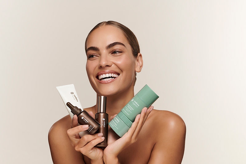 Woman holding endota skincare products