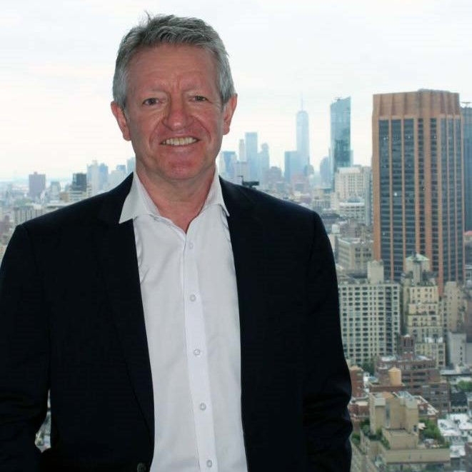Photo of Tony Davis with buildings in the background