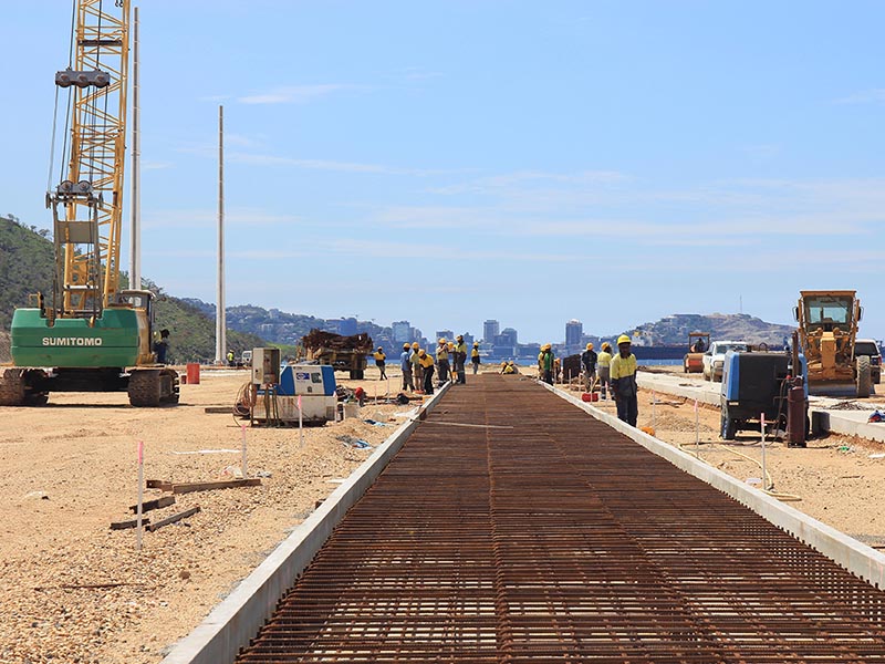 Construction featuring concrete reinforcement at building site in PNG with works and construction machinery
