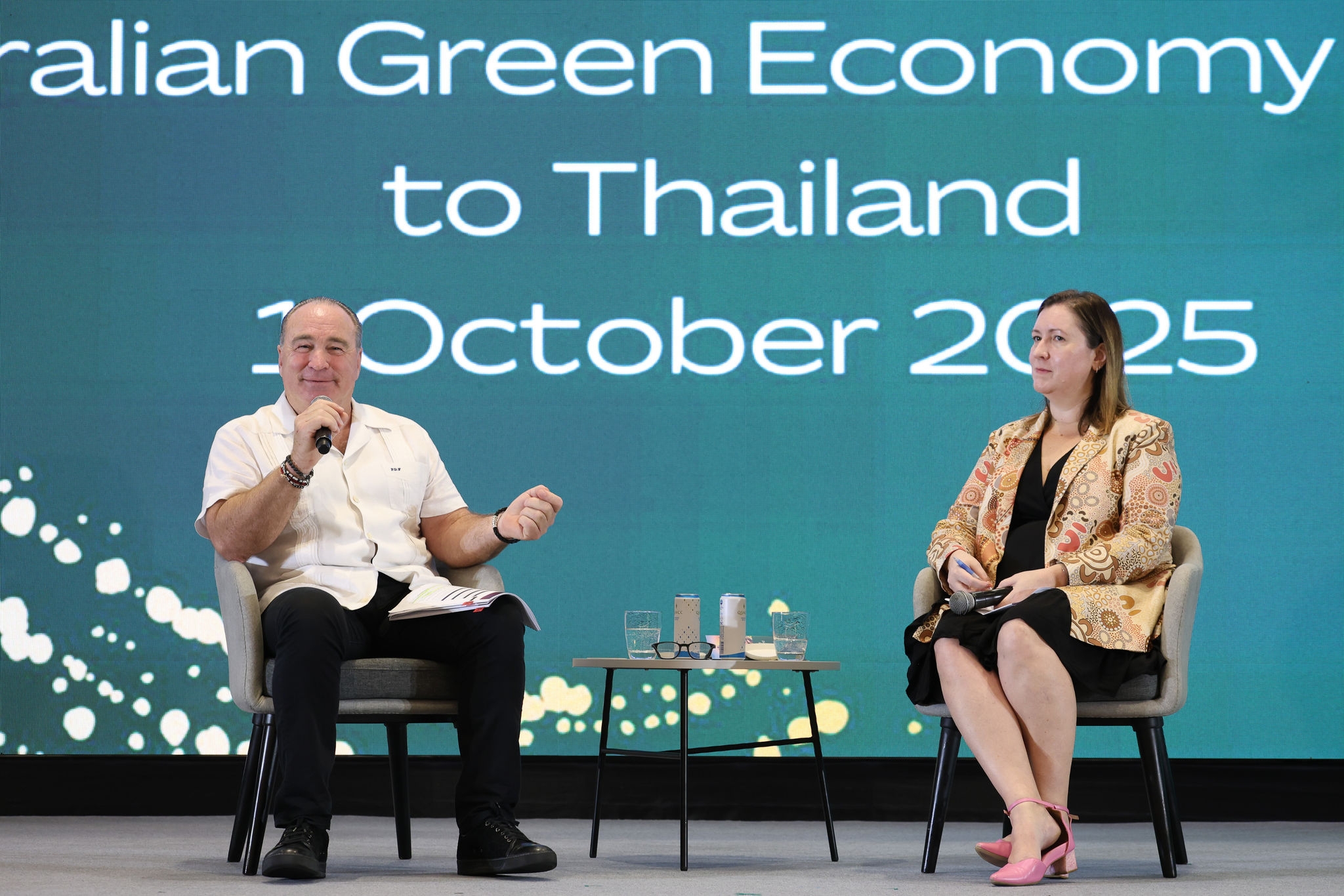 Peter Fox of Linfox and Amelia Walsh of Austrade speaking on stage.