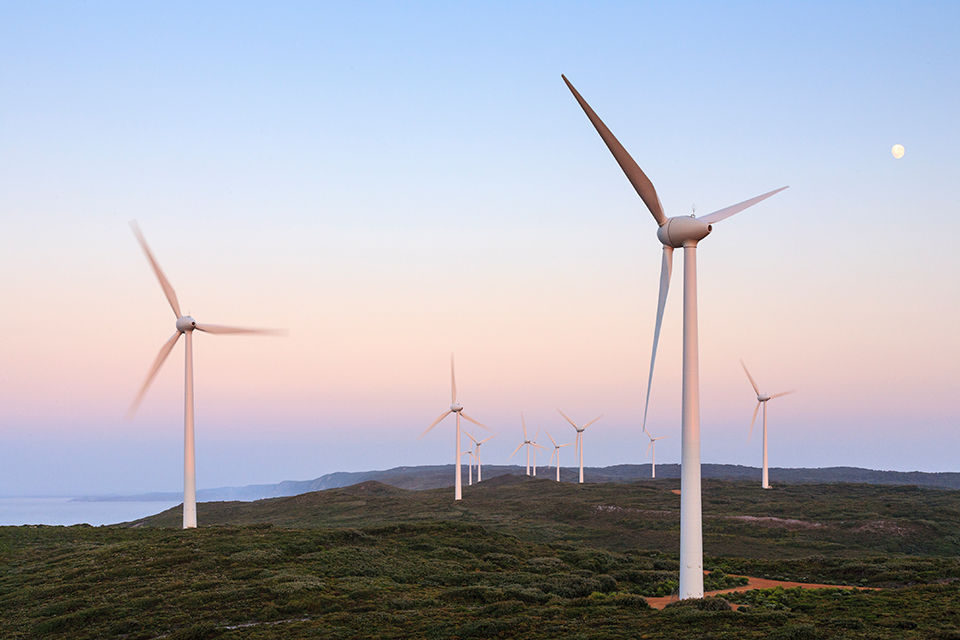 Wind turbines at sunrise with pink sky