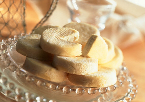 Stack of goat cheese on plate, close-up 