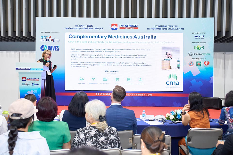 Person presenting at a conference for complementary medicines